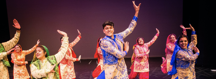 Indian Student Association smiling and performing dance
